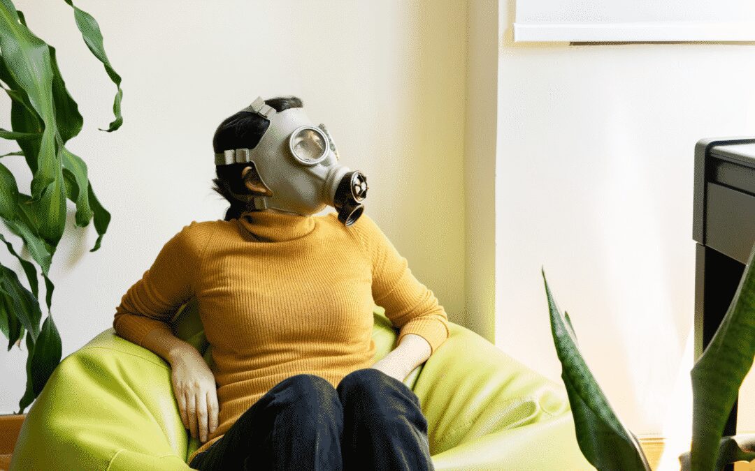 women with gas mask sitting in bean bag chair