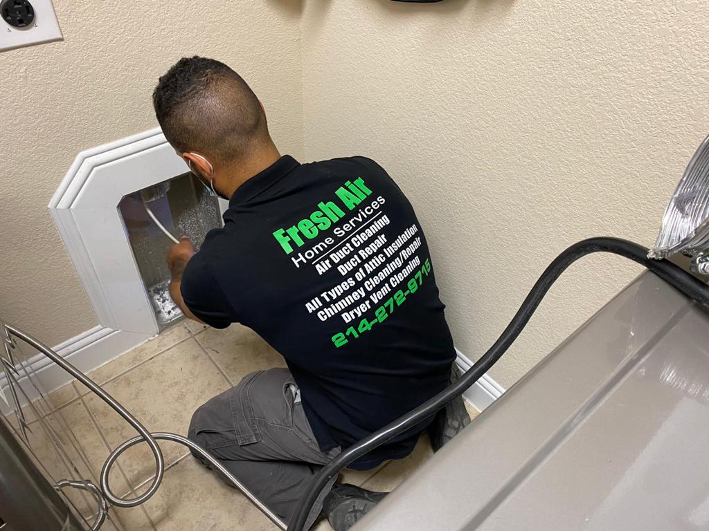 Dryer vent cleaning in Dallas - A Fresh Air Duct Cleaning technician cleans the dryer vent of a customer's home.