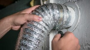 Someone installs an dryer vent hose for a homeowner who found the answer to the question, "What is the best type of dryer vent hose?"