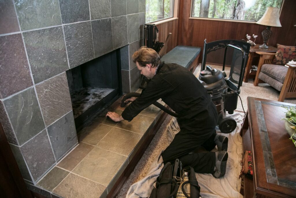 A professionals helps with chimney maintenance 