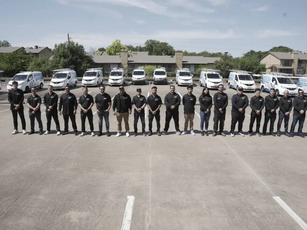 our full air duct cleaning team, with their trucks behind them